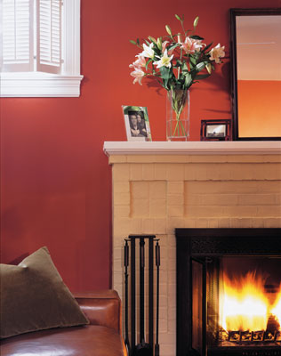 The painted brick of the fireplace echoes the painted brick on the home’s exterior. Lightening the color of the townhouse minimizes the “heat island” effect often plaguing urban areas.